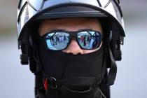 FILE - A U.S. Customs and Border Patrol agent looks on during a protest outside the Federal Bui ...