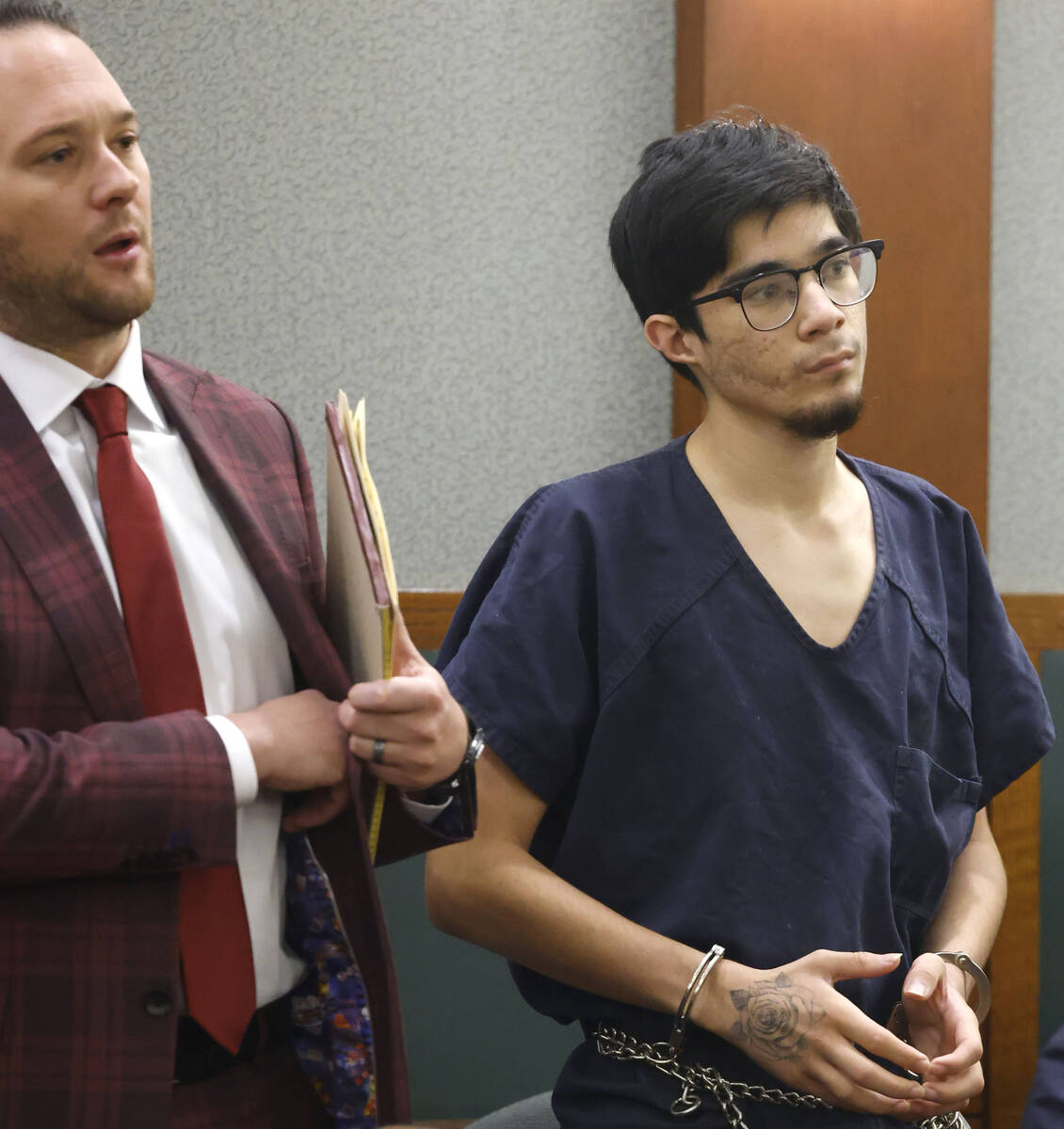 Carlos Blakely, right, a suspect in the Pahrump shooting at a park, appears in court with his a ...