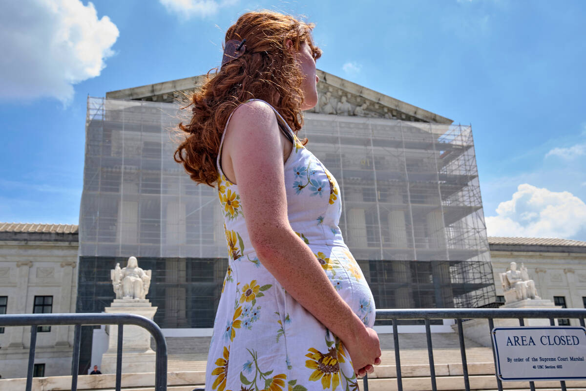 FILE - Mairelise Robinson, a U.S. citizen who is 6 months pregnant, attends a protest in suppor ...