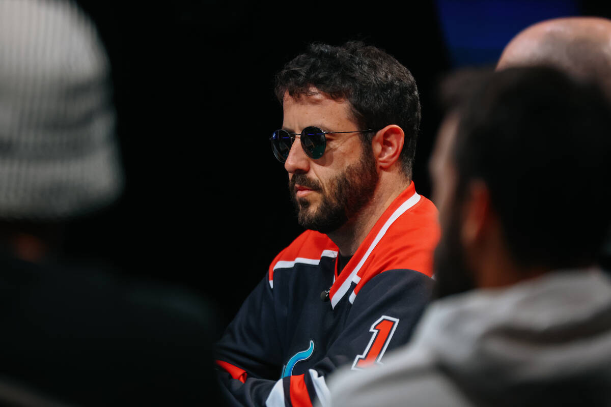 Greg Merson plays at feature table two during day five of the World Series of Poker tournament ...