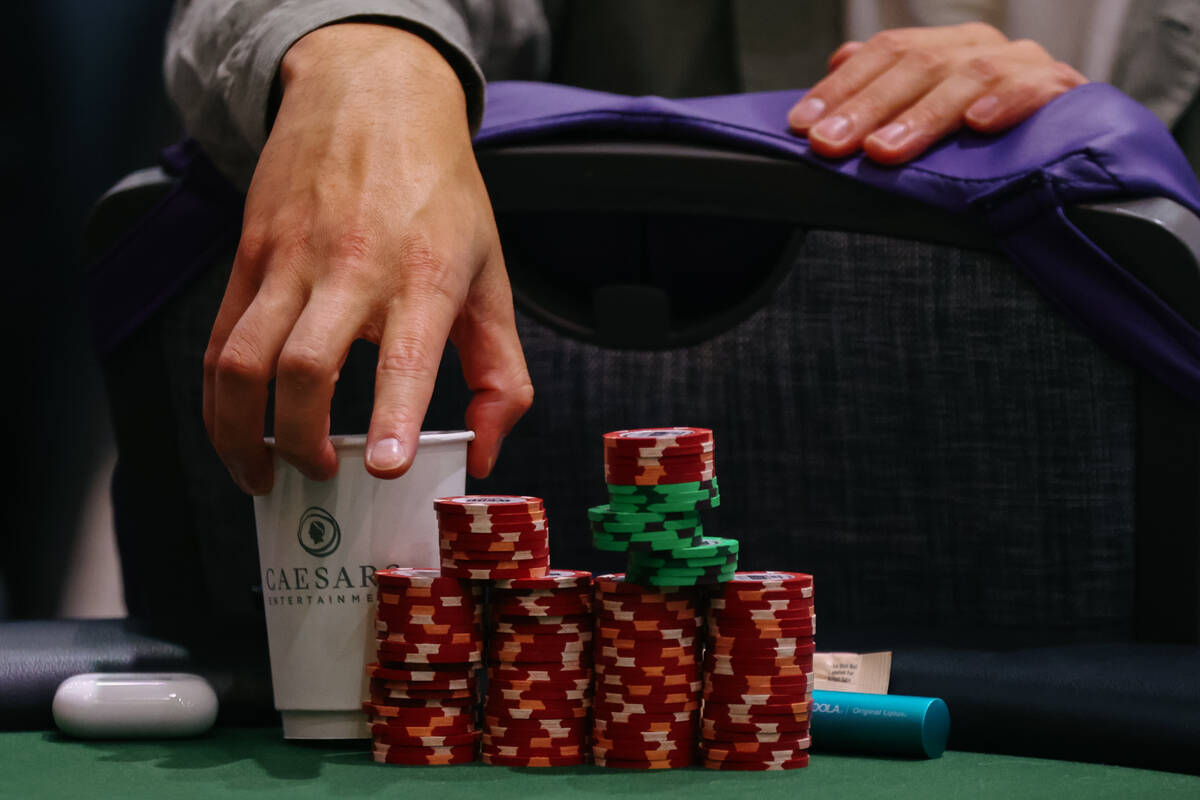 A player grabs a cup while receiving a massage in the middle of a game at day five of the World ...