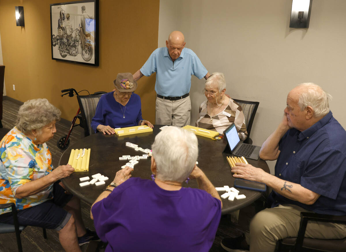 Dr, Richard Berman, center standing, watches as residents at the retirement community Carnegie ...
