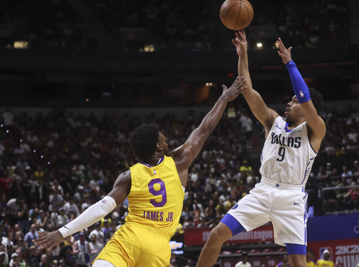Dallas Mavericks guard Ryan Nembhard (9) shoots over Los Angeles Lakers guard Bronny James (9) ...