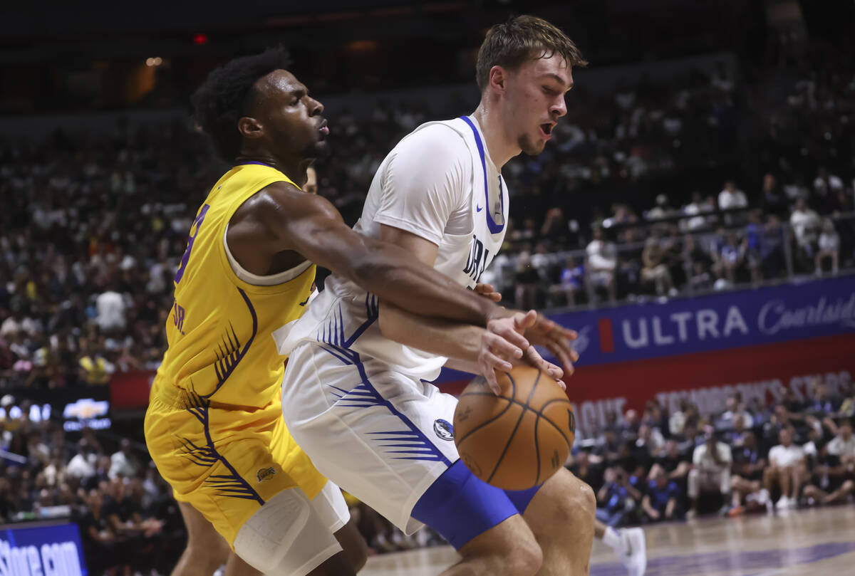 Los Angeles Lakers guard Bronny James, left, defends against Dallas Mavericks Cooper Flagg (32) ...
