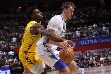 Los Angeles Lakers guard Bronny James, left, defends against Dallas Mavericks Cooper Flagg (32) ...