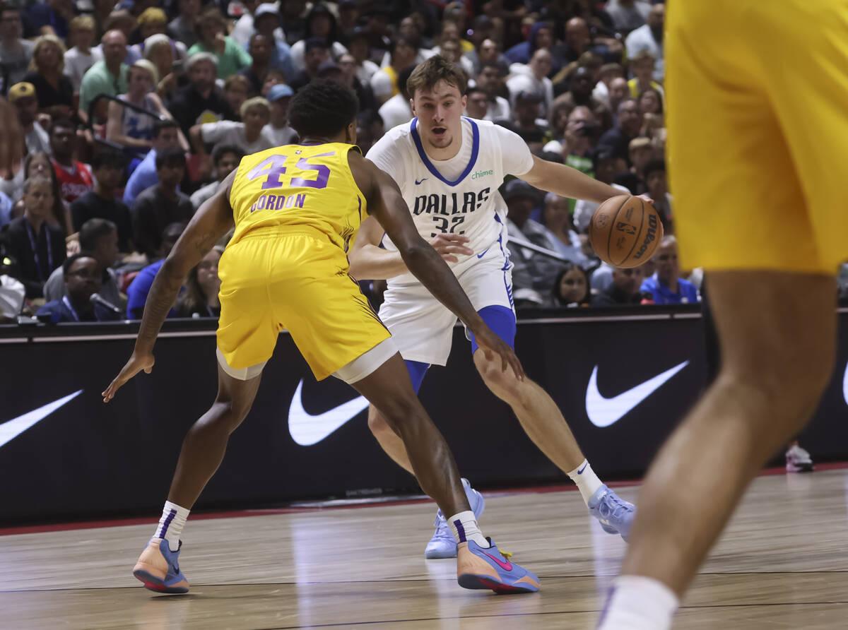 Dallas Mavericks Cooper Flagg (32) drives the ball against Los Angeles Lakers guard DaJaun Gord ...