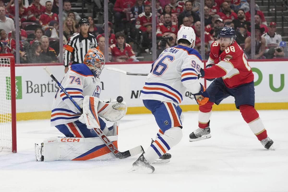 Edmonton Oilers goaltender Stuart Skinner (74) stops a shot on goal by Florida Panthers defense ...