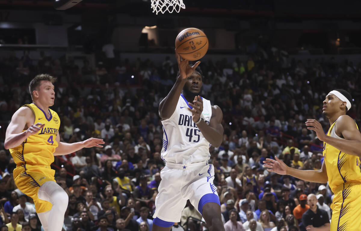 Dallas Mavericks center Moussa Cisse (45) passes the ball under pressure from the Los Angeles L ...