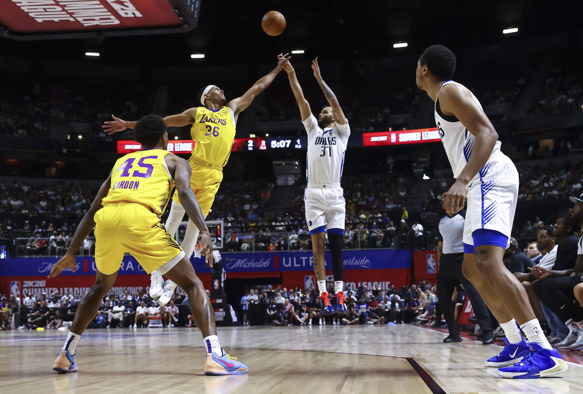 Dallas Mavericks forward Jordan Hall (37) shoots under pressure from Los Angeles Lakers forward ...