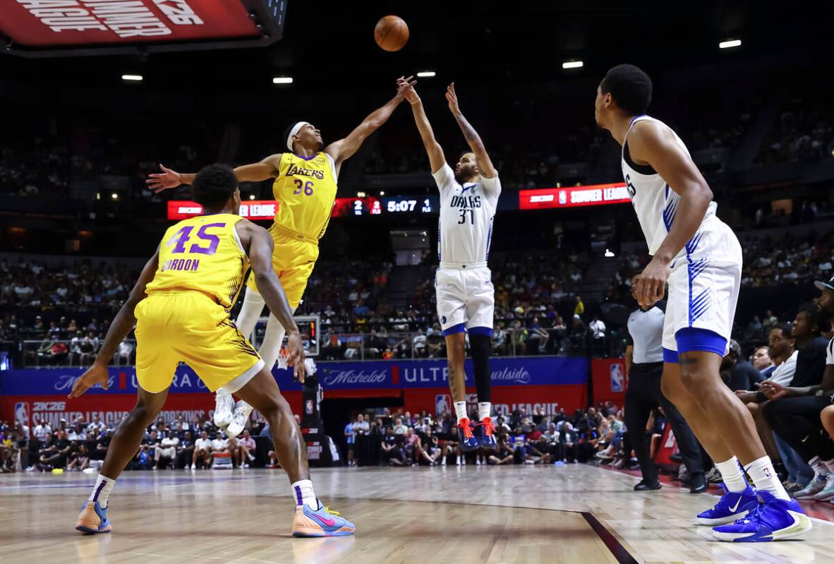 Dallas Mavericks forward Jordan Hall (37) shoots under pressure from Los Angeles Lakers forward ...