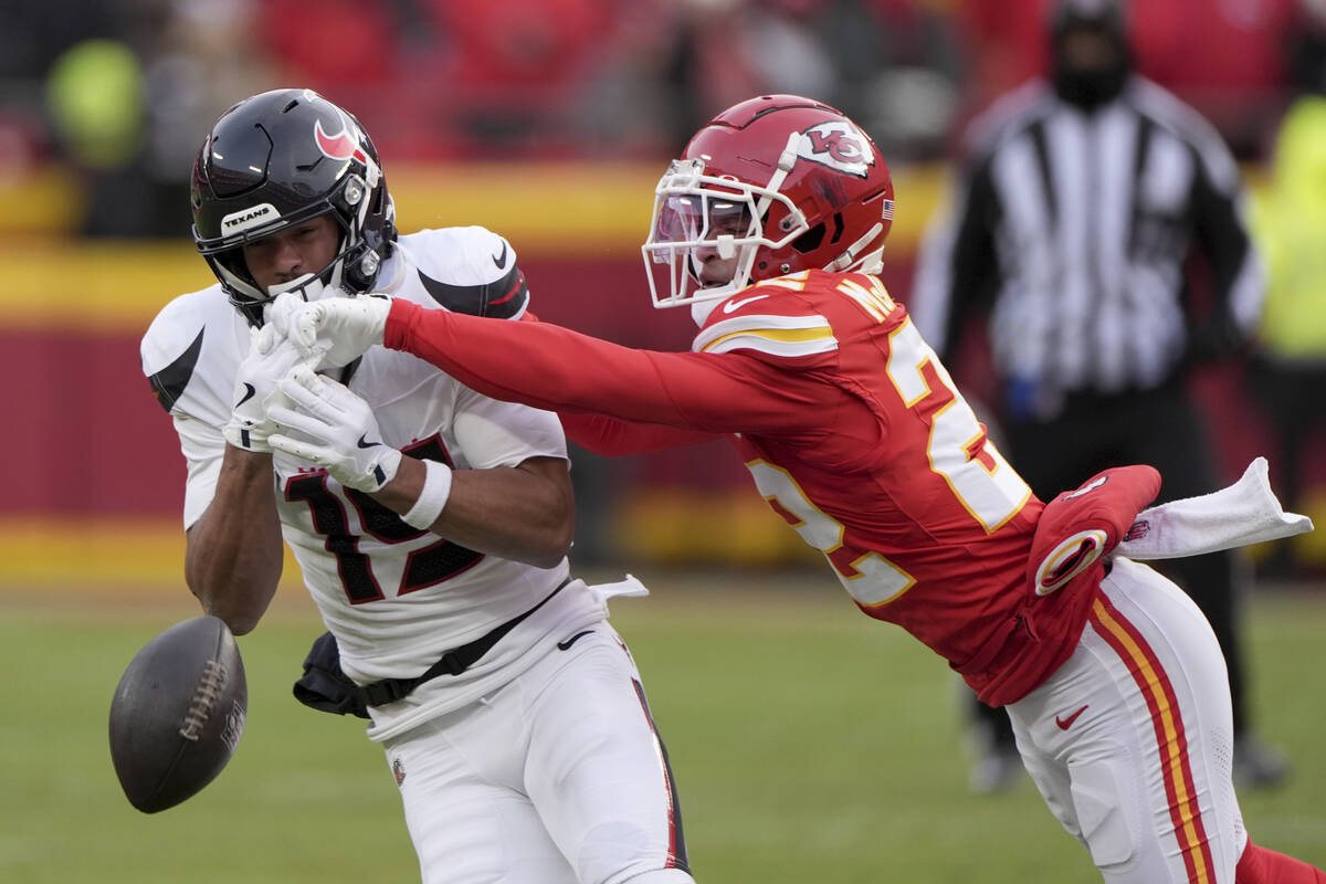 Kansas City Chiefs cornerback Trent McDuffie, right, breaks up a pass intended for Houston Texa ...