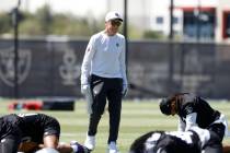 Raiders head coach Pete Carroll watches as players stretch during the 2025 rookie mini camp at ...
