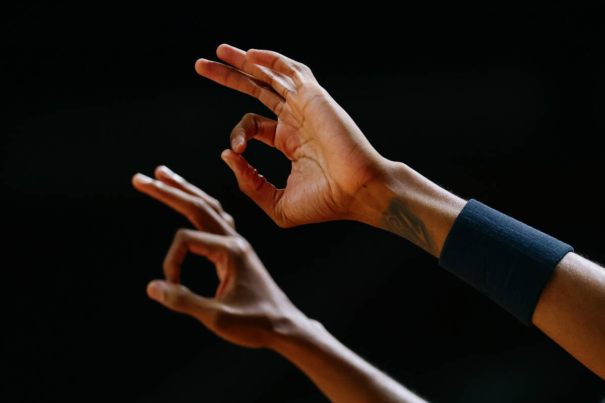 Atlanta Hawks players on the sidelines hold up three fingers after their team made a three-poin ...