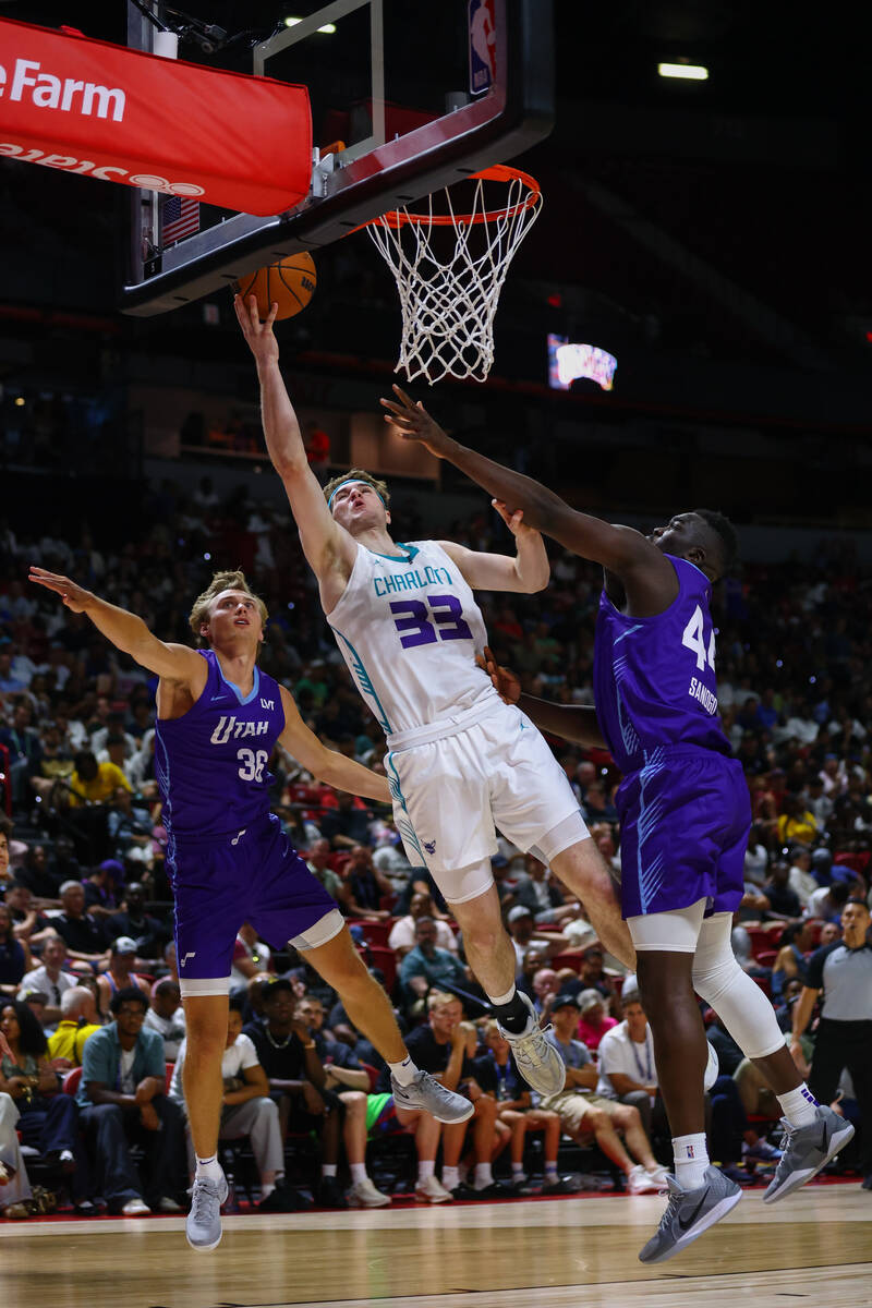 Charlotte Hornets forward Liam McNeeley (33) attempts a layup while Utah Jazz guard/forward Dan ...