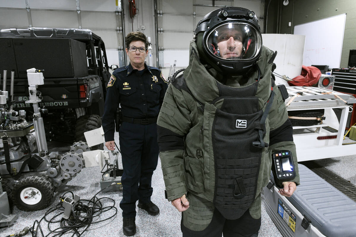 Las Vegas Fire and Rescue Bomb Squad Commander Jamie Sypniewicz poses behind Lt. Chris Stiles w ...