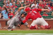 Atlanta Braves' Drake Baldwin, left, is tagged out at home by St. Louis Cardinals catcher Pedro ...