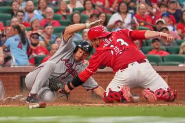 Atlanta Braves' Drake Baldwin, left, is tagged out at home by St. Louis Cardinals catcher Pedro ...