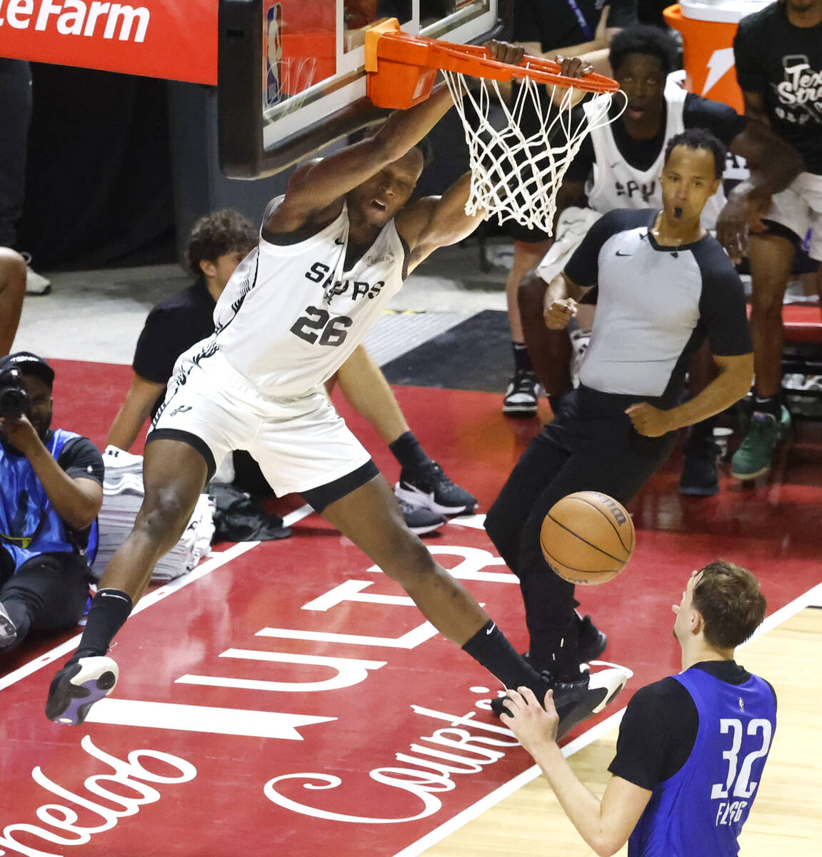 San Antonio Spurs' forward Osayi Osifo (26) dunks as Dallas Mavericks's forward Cooper Flagg (3 ...