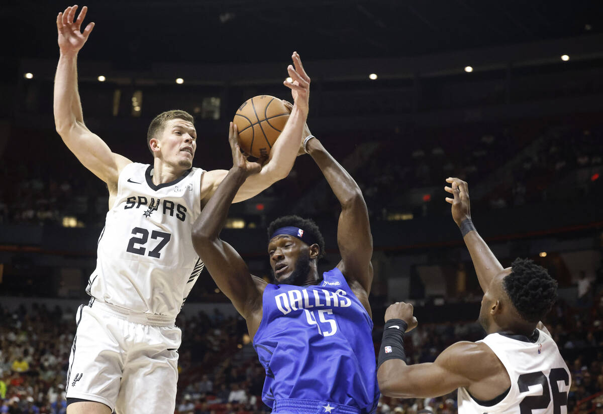 Dallas Mavericks' center Moussa Cissé (45) is fouled by San Antonio Spurs' forward Riley ...