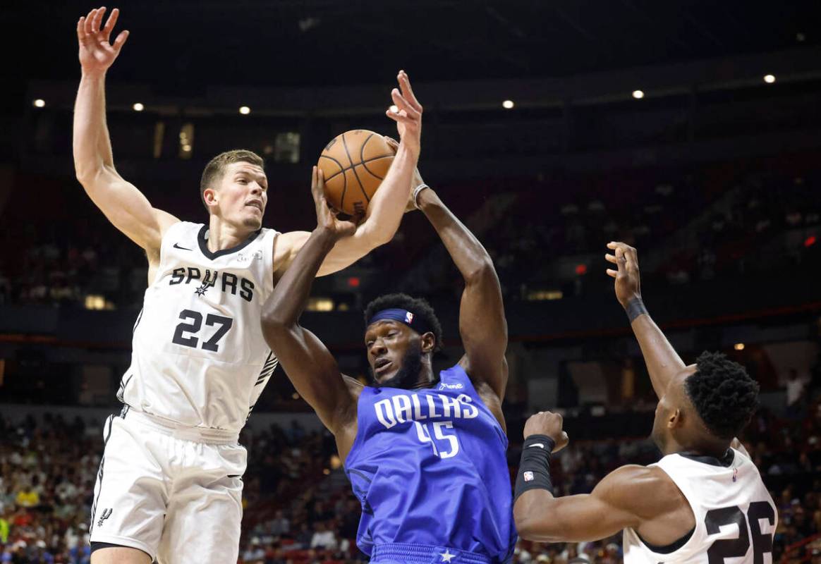 Dallas Mavericks' center Moussa Cissé (45) is fouled by San Antonio Spurs' forward Riley ...