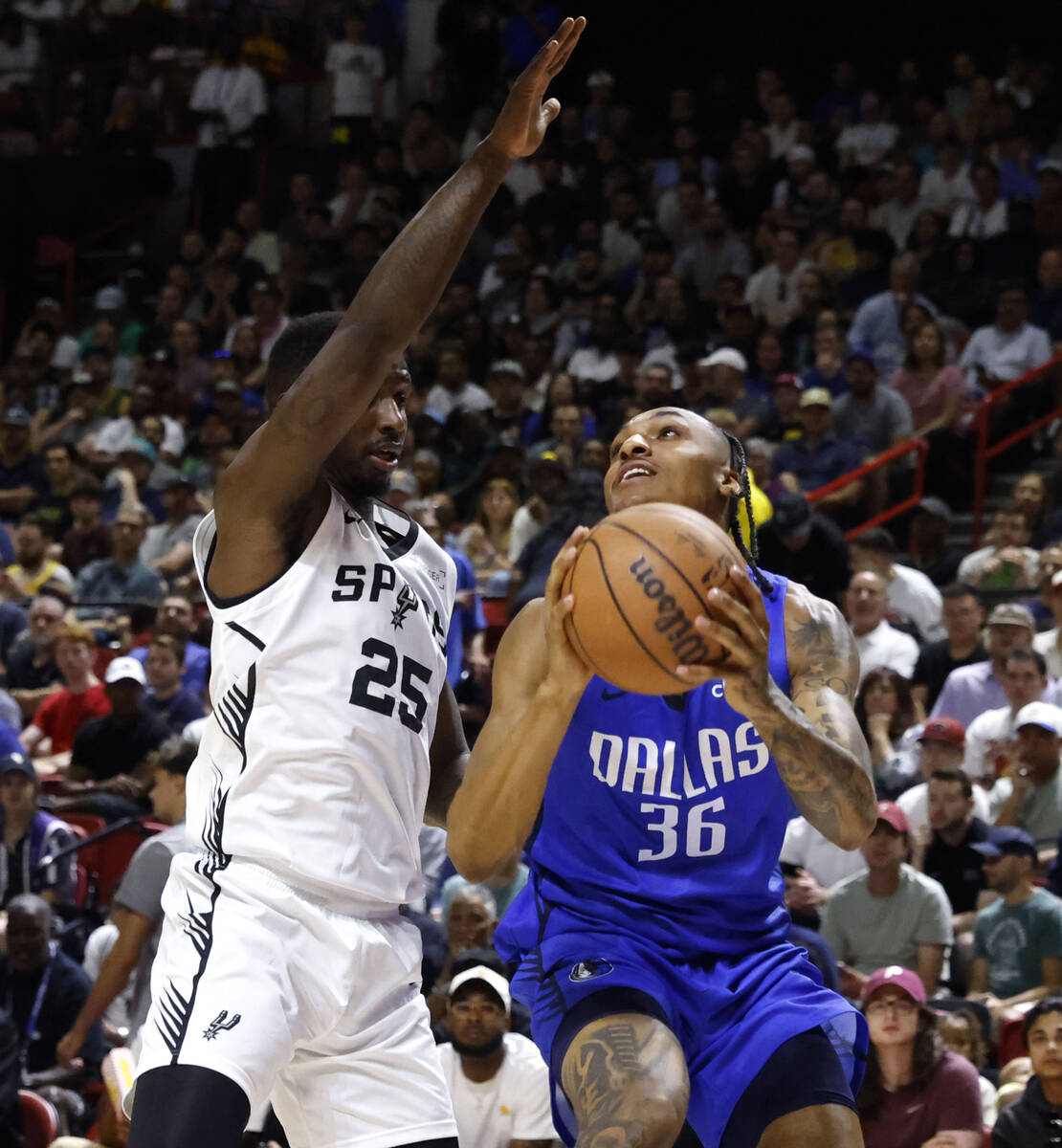 Dallas Mavericks' forward Maxwell Lewis (36) tries to shoot for the hoop as San Antonio Spurs' ...