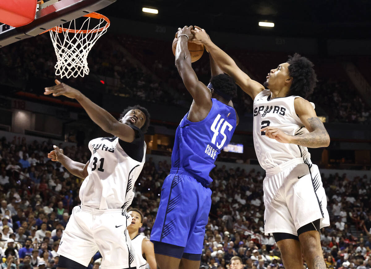 Dallas Mavericks center Moussa Cissé (45) has his shot blocked by San Antonio Spurs' guard ...