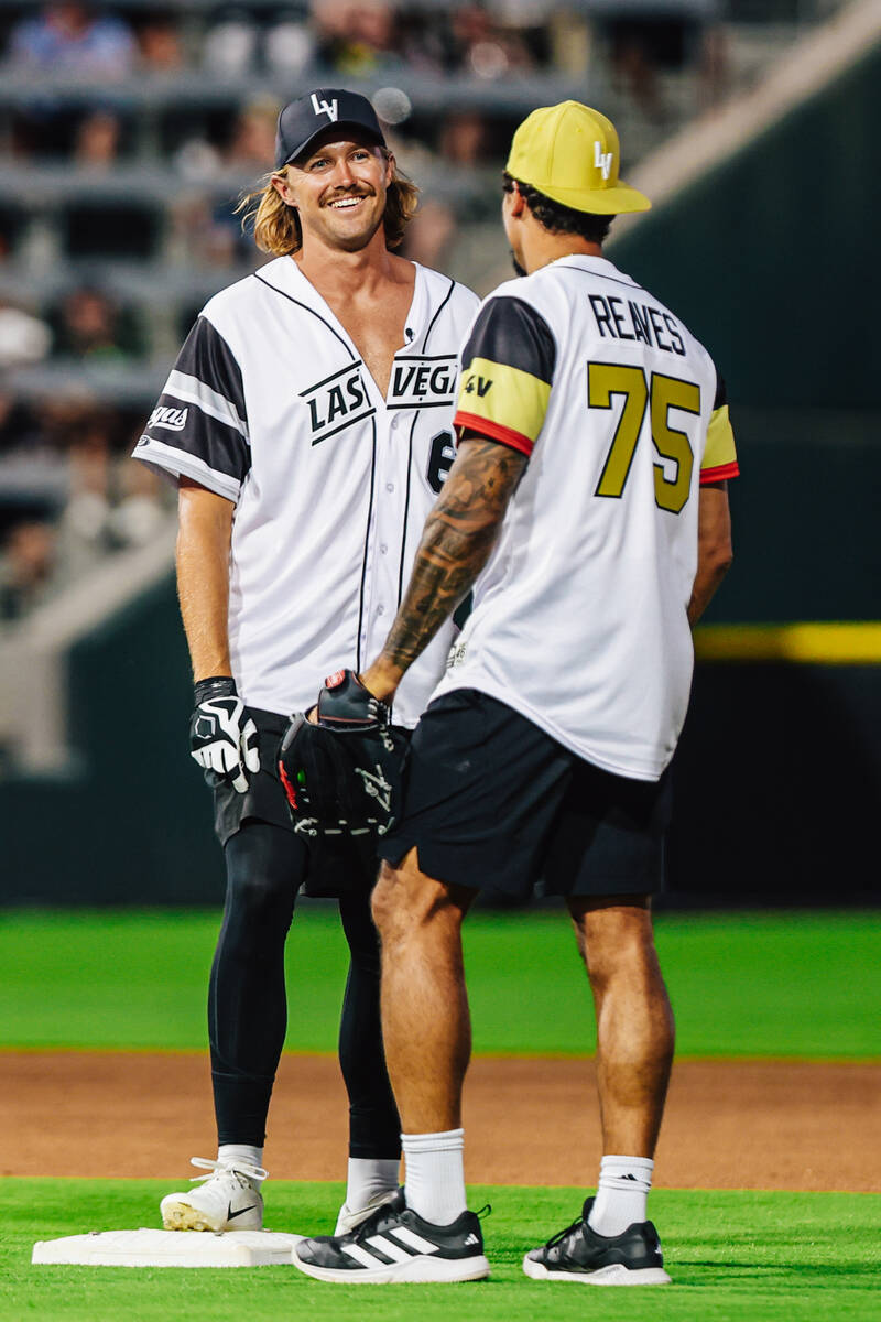 Raiders punter AJ Cole, left, smiles as he talks to San Jose Sharks right winger Ryan Reaves du ...
