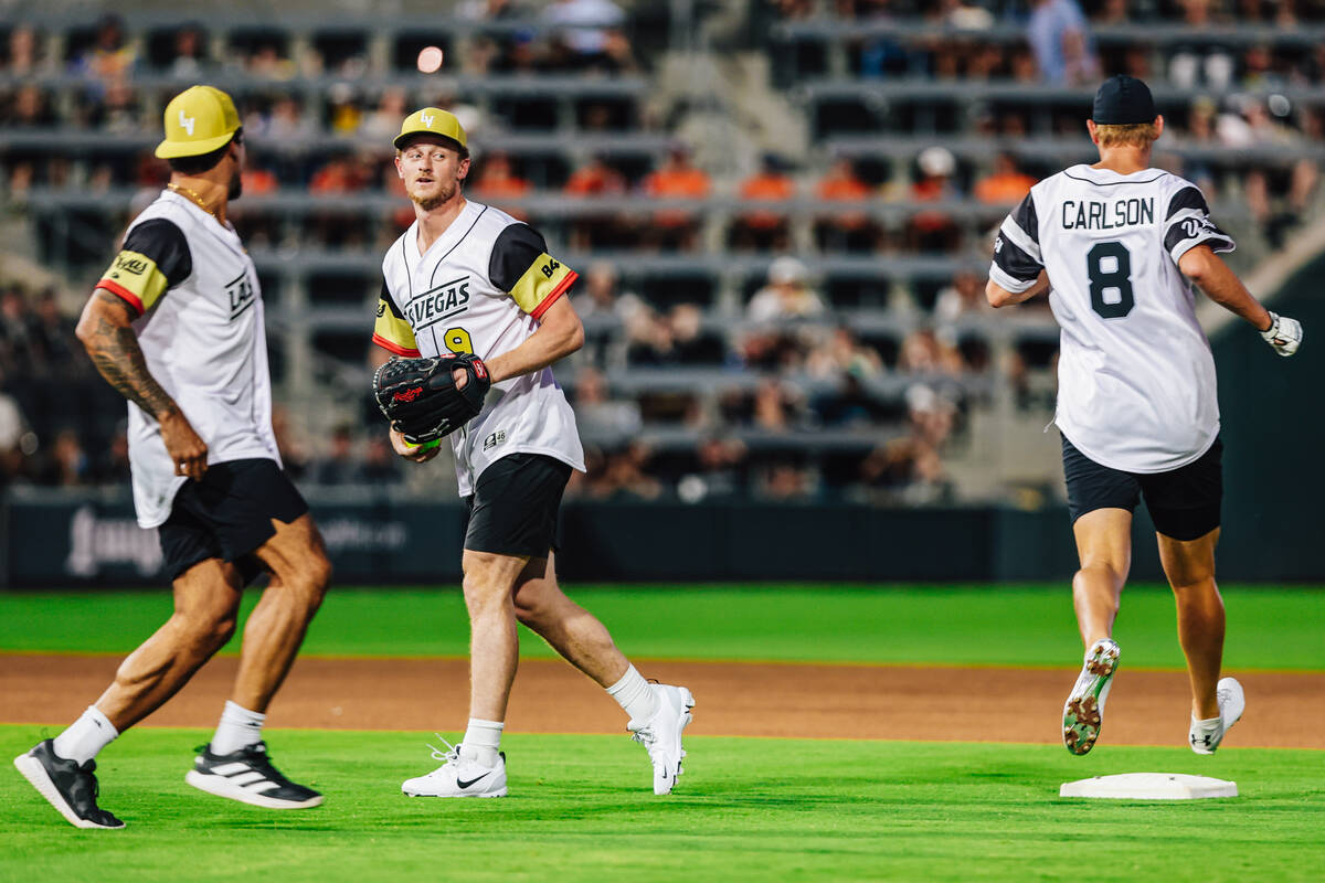 Golden Knights center Jack Eichel (9) eyes Raiders placekicker Daniel Carlson (8) as he runs to ...