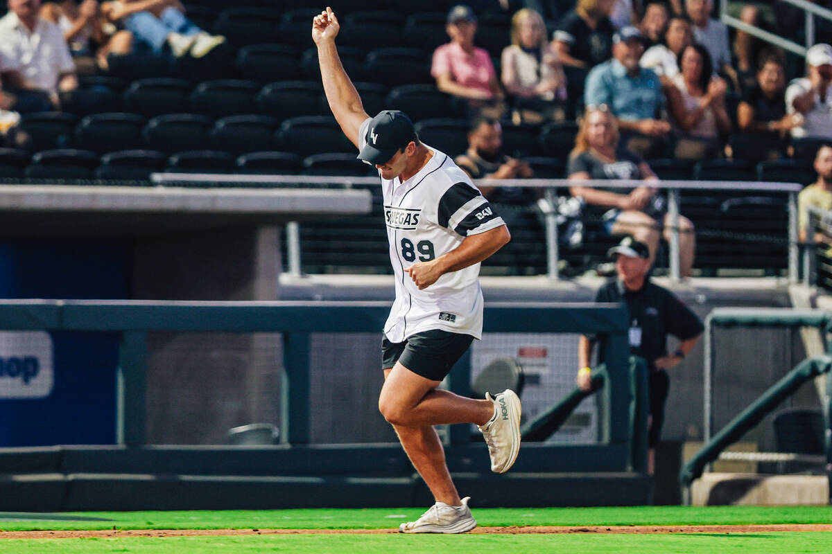 Raiders tight end Brock Bowers pumps his fist during a home run during a Battle For Vegas chari ...