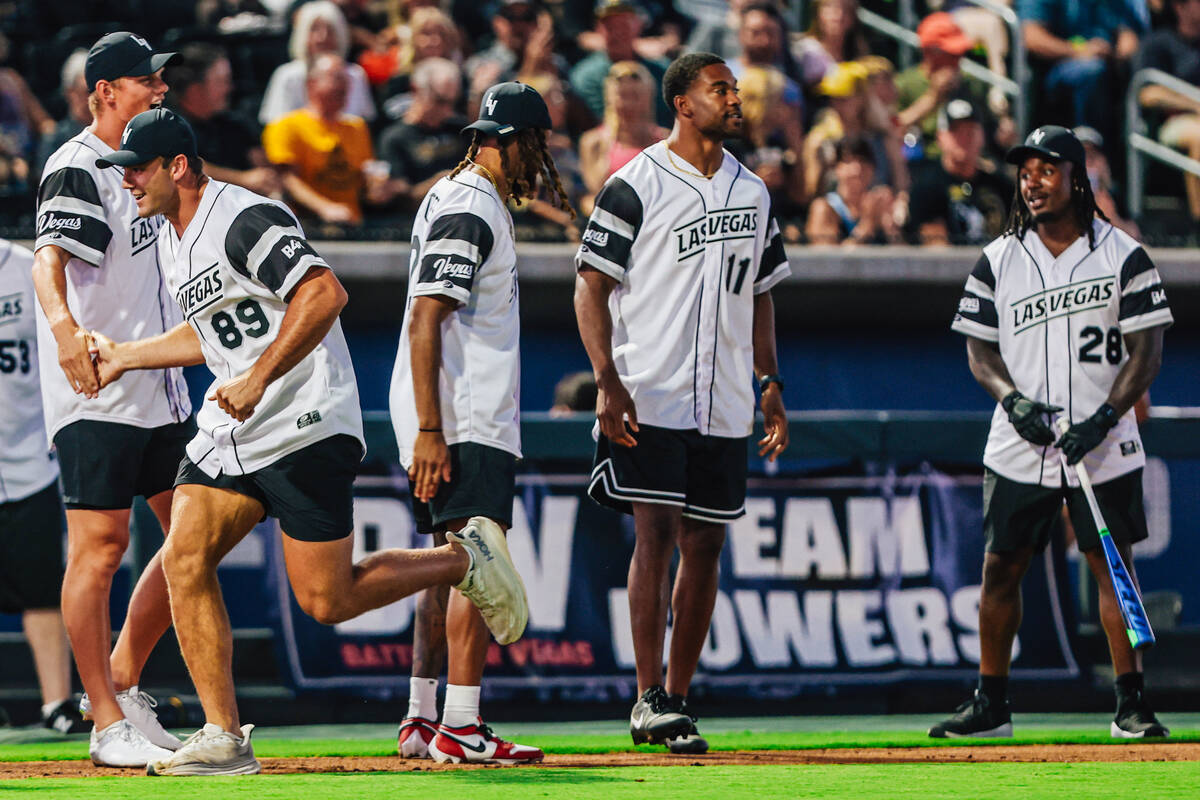 Raiders tight end Brock Bowers (89) high-fives his teammates during a home run during a Battle ...