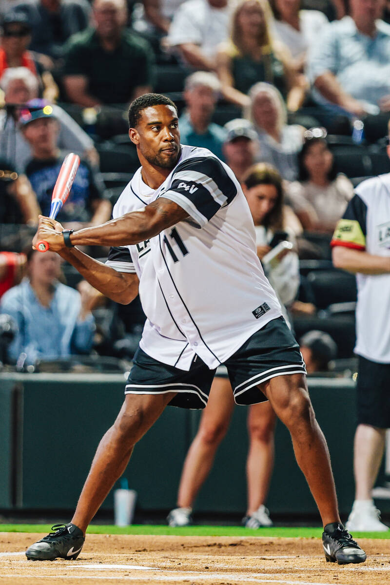 Raiders safety Jeremy Chinn goes up to bat during a Battle For Vegas charity softball game betw ...