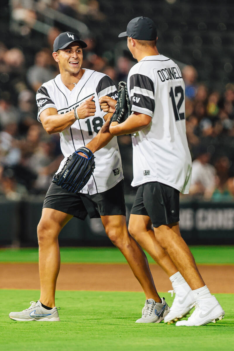 Raiders wide receiver Jack Bech (18) fist bumps Raiders quarterback Aidan O’Connell duri ...