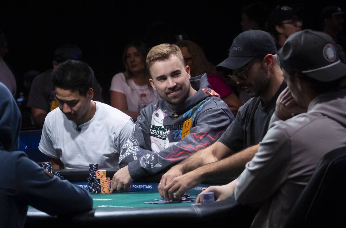 Adam Hendrix, center, looks on during day 8 of the World Series of Poker Main Event at Horsesho ...