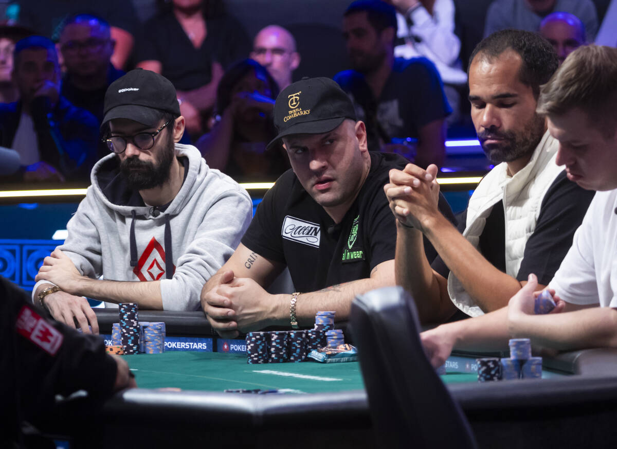 Michael Mizrachi, center, looks on during day 8 of the World Series of Poker Main Event at Hors ...