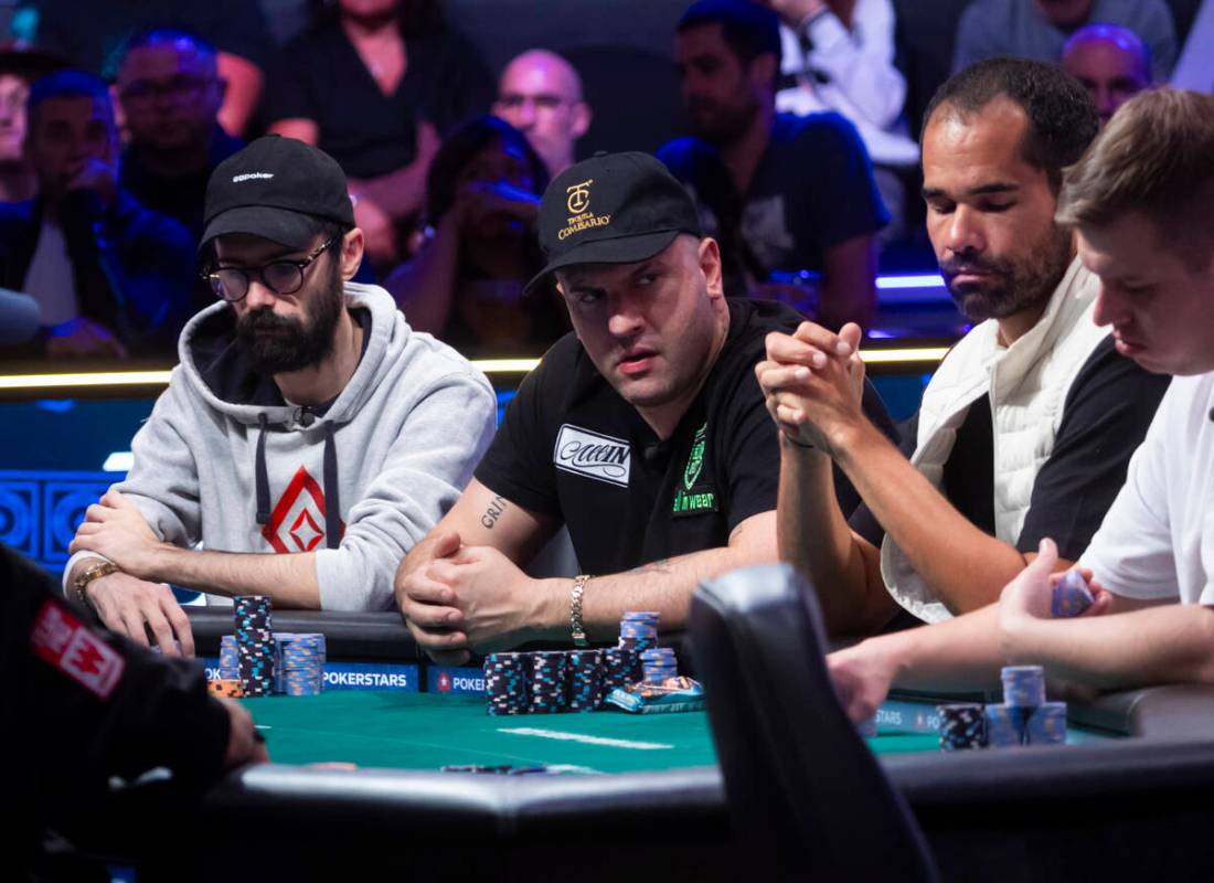 Michael Mizrachi, center, looks on during day 8 of the World Series of Poker Main Event at Hors ...