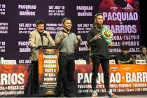 Manny Pacquiao, center, and WBC welterweight champion Mario Barrios pose at a news conference i ...
