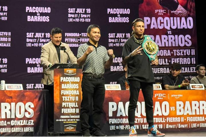 Manny Pacquiao, center, and WBC welterweight champion Mario Barrios pose at a news conference i ...