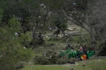 People clean-up along the river due to flooding in Kerrville, Texas, Monday, July 7, 2025. (AP ...