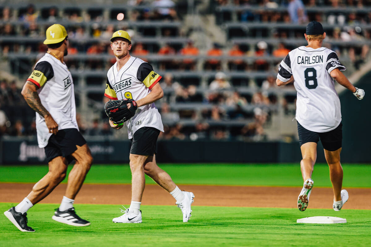 Golden Knights center Jack Eichel (9) eyes Raiders placekicker Daniel Carlson (8) as he runs to ...