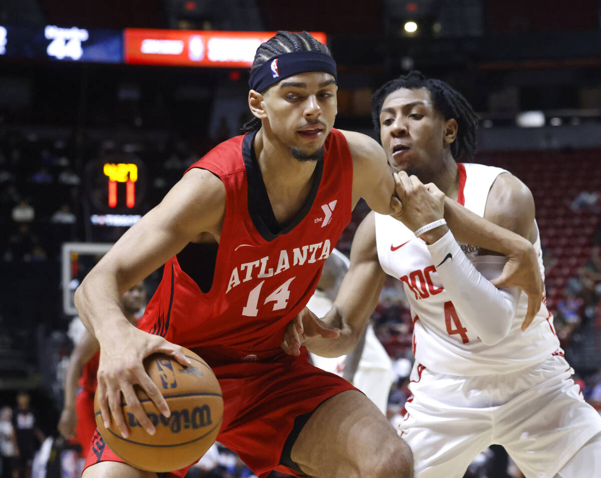 Atlanta Hawks forward Asa Newell (14) protects the ball from Houston Rockets guard Kennedy Chan ...