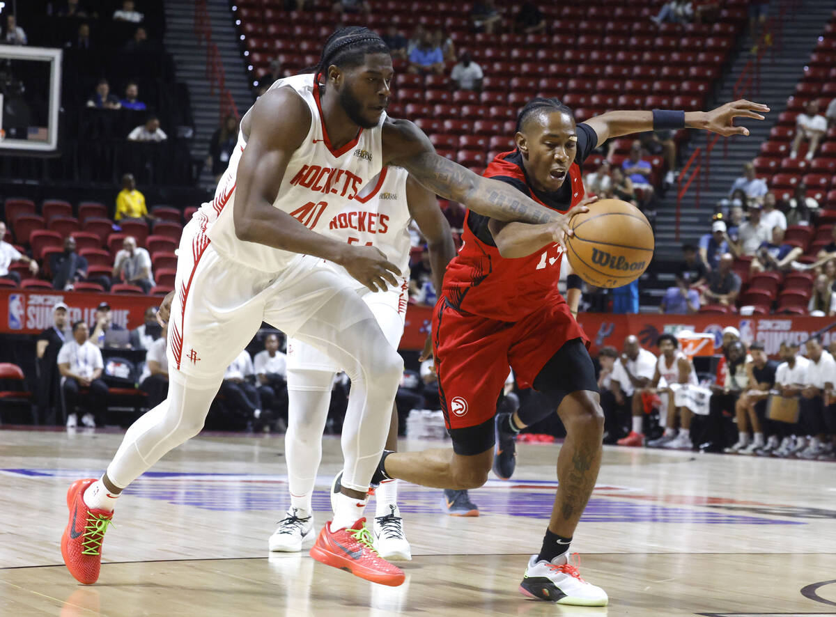 Houston Rockets forward Cameron Matthews, left, and Atlanta Hawks forward Javan Johnson fight f ...