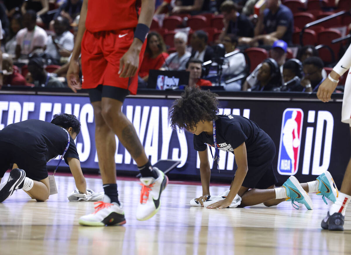 Floor crew wipe the floor during the NBA Summer League game between the Atlanta Hawks and the H ...