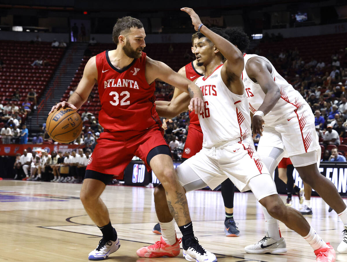 Atlanta Hawks forward Jack McVeigh (32) protects the ball from Houston Rockets forward Jermaine ...