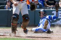 Basic runner Mason Neville (26) slides safely home as Bishop Gorman catcher Billy Scaldeferri ( ...