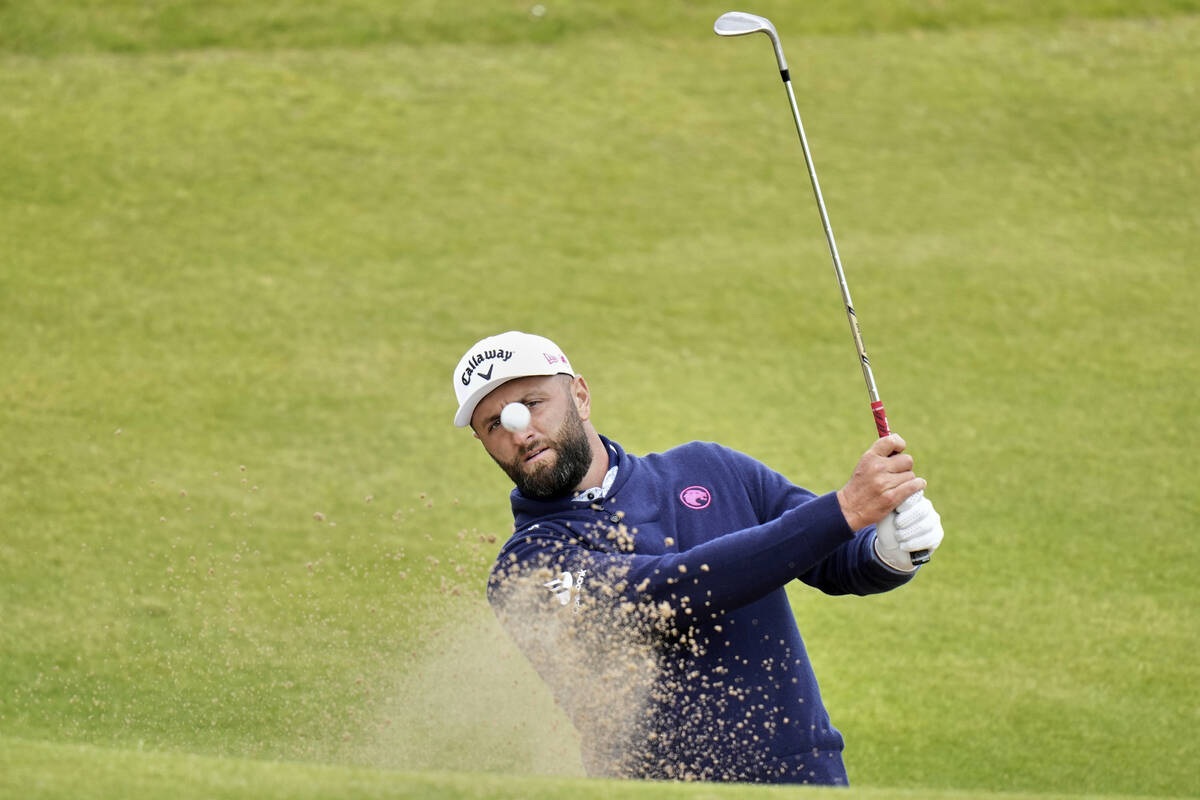 Jon Rahm of Spain plays out of a bunker on the 7th green during a practice round for the Britis ...