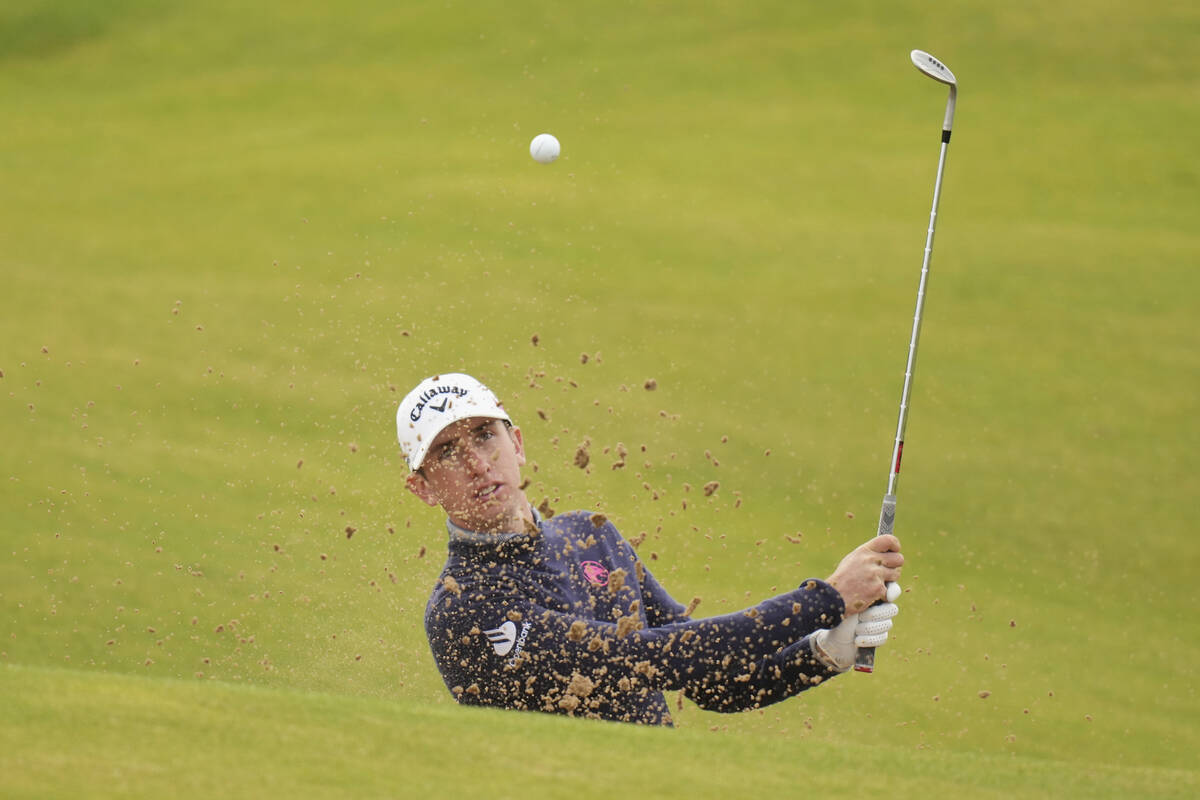 Tom McKibbin of Northern Ireland plays out of a bunker on the 8th green during a practice round ...