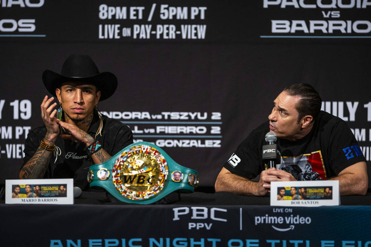 Mario Barrios looks on as his trainer Bob Santos speaks during a press conference for his upcom ...