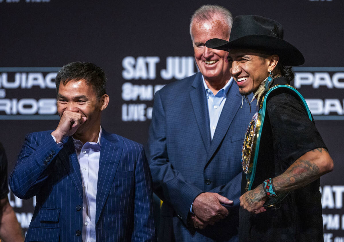 Manny Pacquiao and Mario Barrios share a laugh after a face off for the crowd with promoter Tom ...