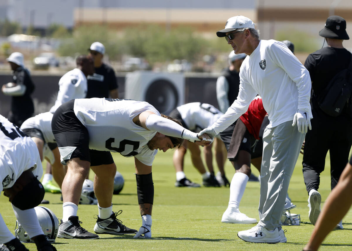 Raiders center Jackson Powers-Johnson (58) shakes hands with head coach Pete Carroll as he stre ...