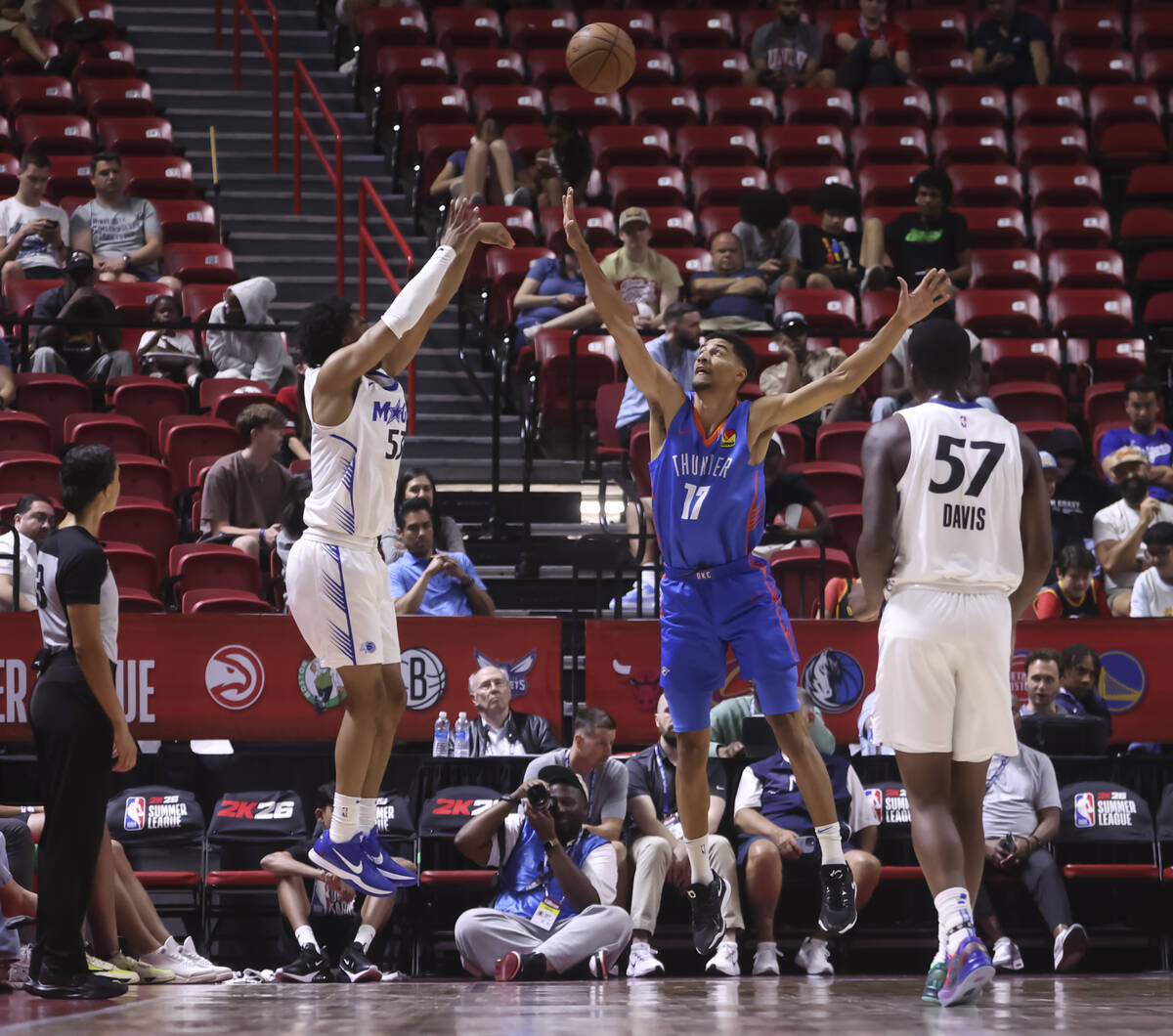 Orlando Magic guard Jaden Akins (53) shoots over Oklahoma City Thunder forward Malevy Leons (17 ...